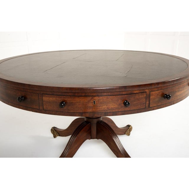 19th century english regency mahogany drum or rent table of good size. this table has a splayed base with four fluted legs...