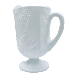 Vintage Milk Glass Footed Pitcher With Embossed Grape and Vine Pattern For Sale