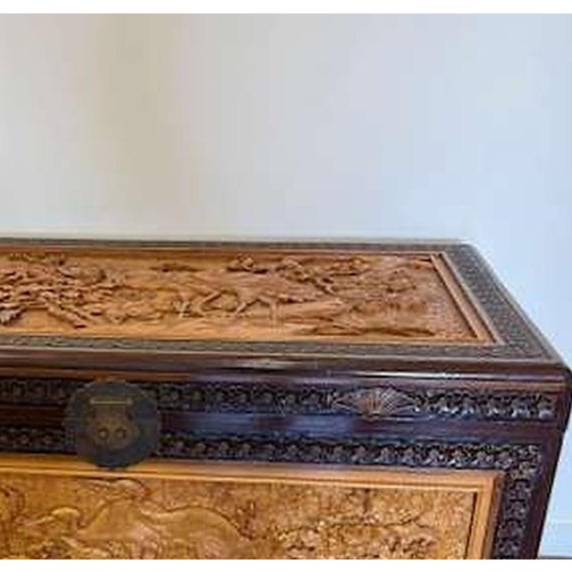 20th century carved sandalwood chest decorated with vegetal and zoomorphic motifs; with metal hardware. Dimensions:...