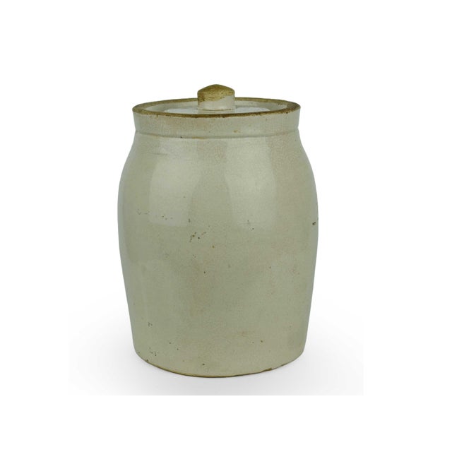 This Antique Early 20th Century American Stoneware Pickle Crock with Lid is a premier example of functional primitive...