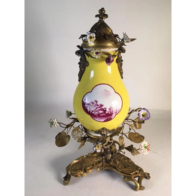 A very rare 19th century Meissen tea pot and stand with bronze doré and flowers. Two faces mounted on the sides Marked on...