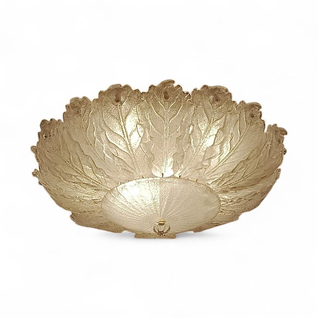 A spectacular ceiling light handcrafted from blown Murano glass. This exceptional piece captures the beauty of Venetian...