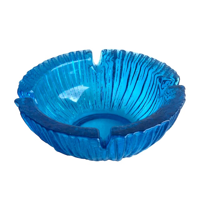 Offered is a heavy textured ashtray designed by Wayne Husted for Blenko Glass in 1963. It is a bright teal color sometimes...