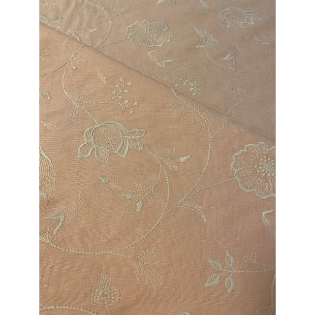 Colefax & Fowler's "Fairfield" fabric in soft pink features a cream colored embroidered floral vine. Fabric is 49.5" wide...