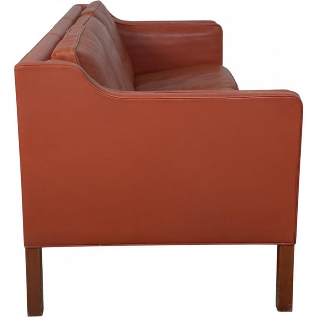 Børge Mogensen 2213 3-seater sofa upholstered in cognac red leather, and with legs of mahogany. The sofa is from 1997 and...