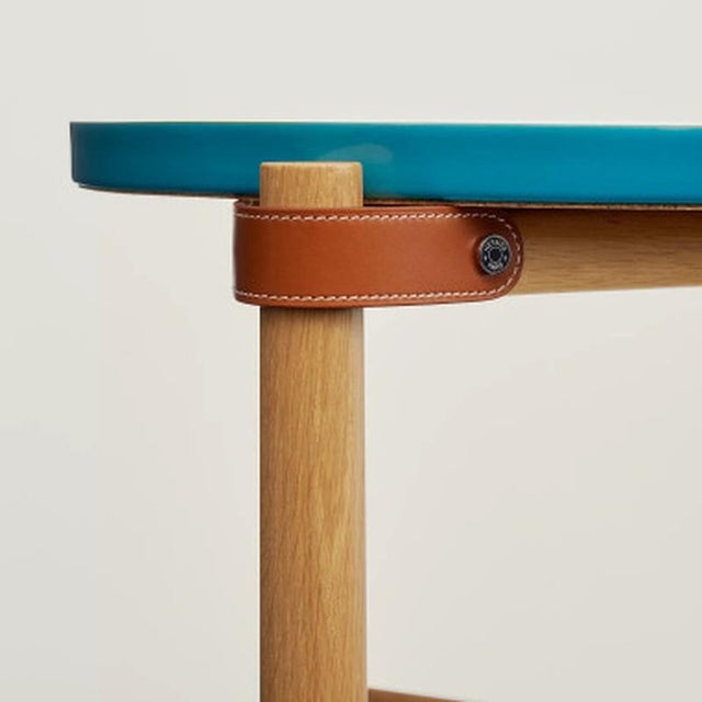 Side table with a porcelain top featuring hand-screen-printed designs - Folding solid oak base - Leather straps "Weaving"...