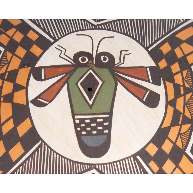 A pottery seed pot by the Acoma potter Diane Lewis. This small seed pot features an intricate design on the top a stylized...