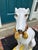 A large Italian glazed terra cotta whippet or greyhound, seated on a tasseled pillow, beautifully-detailed and realistic,...