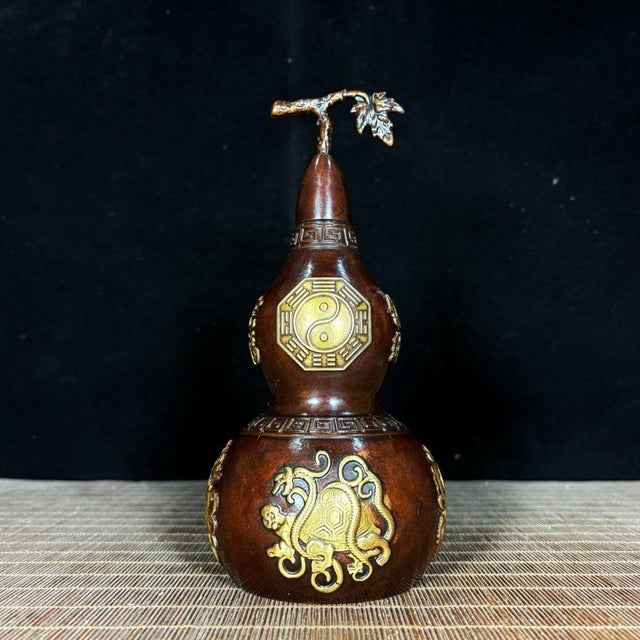 Add a touch of traditional symbolism and protection to your space with this striking gilt bronze gourd (Wu Lou). This...