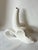 Y2K white ceramic banana bud vase attributed to Jonathan Adler, featuring a playful partially peeled design that reveals...