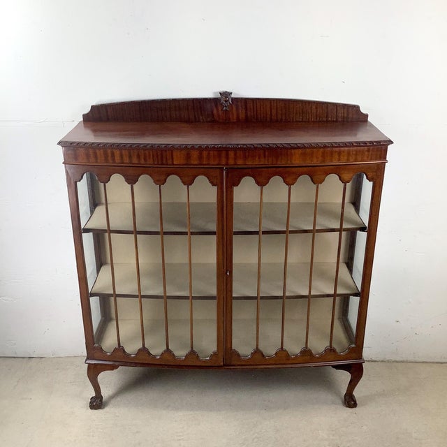 This elegant mahogany display cabinet was crafted in the Chippendale Revival style, reflecting early 20th-century...