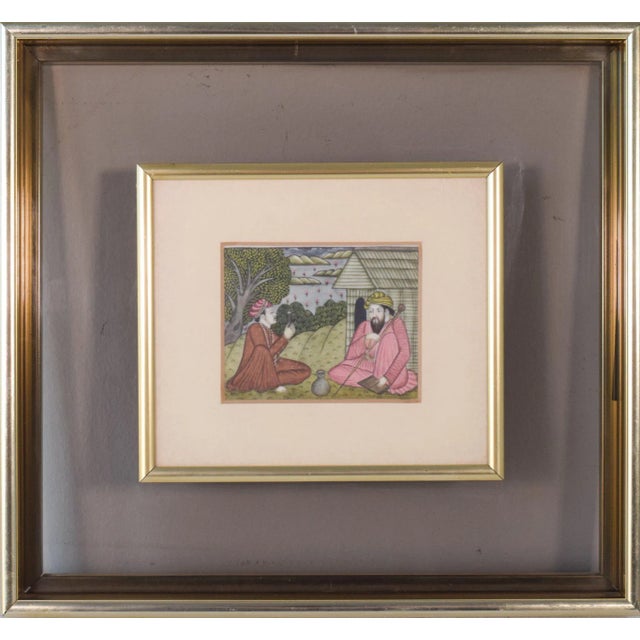 A sense of peace and harmony emanates from this image of two men sitting on the ground, worshipping and studying...