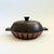 A vintage stoneware pottery lidded serving bowl. Two toned glaze design with a dark brown glaze contrasting with matte...