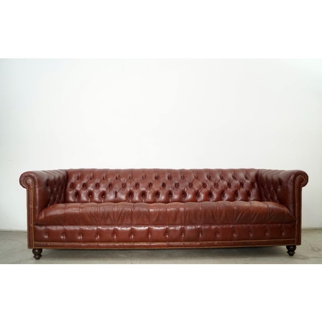 Vintage Hollywood Regency genuine leather couch for sale. This is a long Chesterfield sofa with the classic design and was...