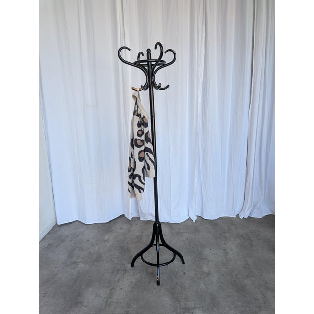 Vintage bentwood coat stand in the style of Thonet, featuring elegantly curved hooks and a sculptural black lacquered...