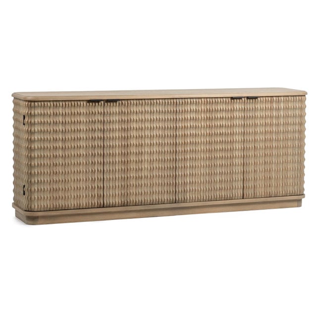 Natural elm wood sideboard distinguished by its unique rippled carved design. The rhythmic carved pattern wraps seamlessly...