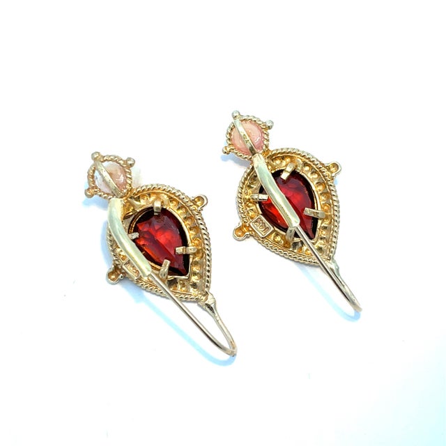 Elegant vintage drop earrings crafted in solid 14K yellow gold, featuring rich pear-shaped garnets accented with luminous...
