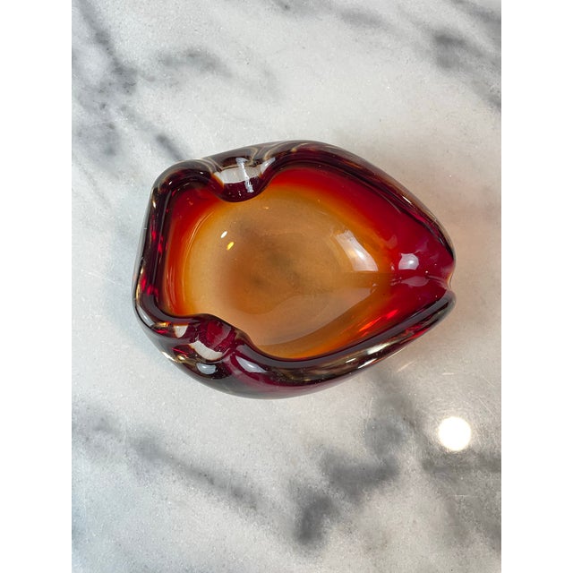Vintage Murano glass bowl or ashtray, likely produced in Italy in the 1960s–1970s. This striking piece features vibrant...