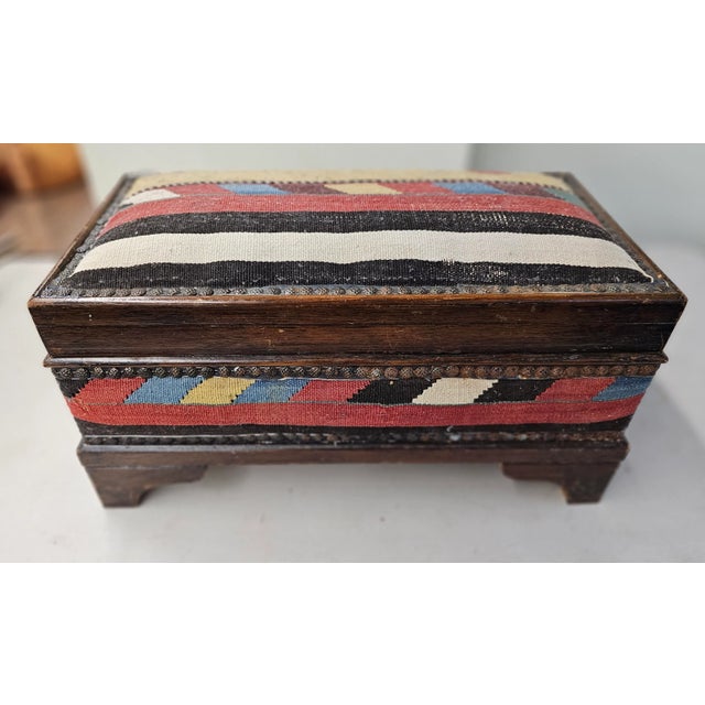 A skillfully Kilim Upholstered Stained Pine Middle Eastern Table Chest with nail head decorated trims. Measures 20.5" in...