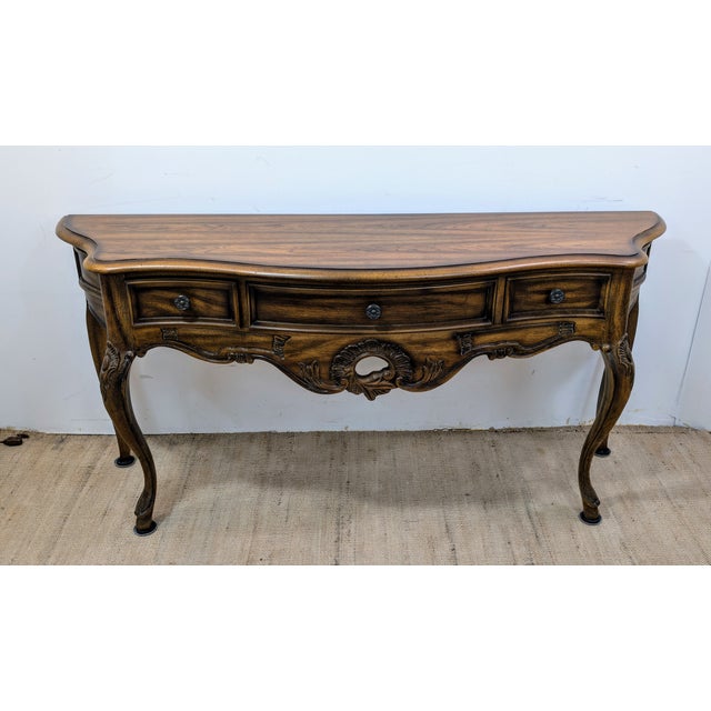 Century furniture French provincial Console table is fastidiously crafted from rich walnut and features an intricate...