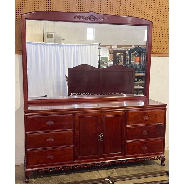 Solid rosewood dresser with six dovetailed drawers with carved pulls, and a center cabinet with two adjustable shelves....