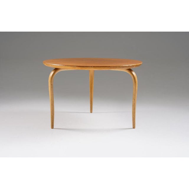 A refined side table by Bruno Mathsson, designed in 1968, showcasing his signature balance of lightness and structural...