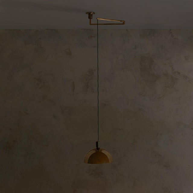 An Italian pendant light attributed to Franco Albini for Sirrah, 1968. The design is anchored by a domed brass shade,...