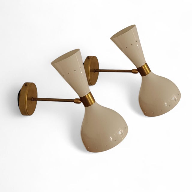 Pair of Stilnovo wall lights, an Italian design from the 1970s. These wall lights feature the Diabolo shape. They are...