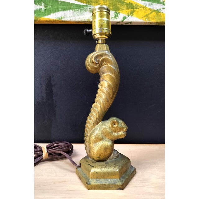 One of a kind cast brass squirrel lamp. Circa 1930's-40's. Stylized squirrel with nut with extravagant tail on hexagonal...