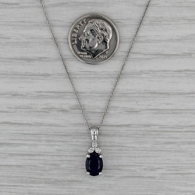 Gemstone Information: - Natural Sapphire - Carats - 1.64ct Cut - Oval Brilliant Color - Dark Blue Treatment - Heated -...