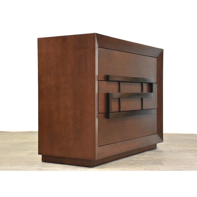 A mid century modern mahogany three drawer dresser with black lacquer pulls made by Maximilian for Karp Furniture....