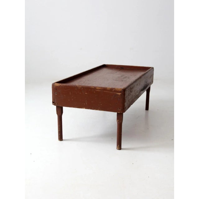 This antique rustic wooden table is the perfect choice for adding character to any room. Its low height and lipped edge...