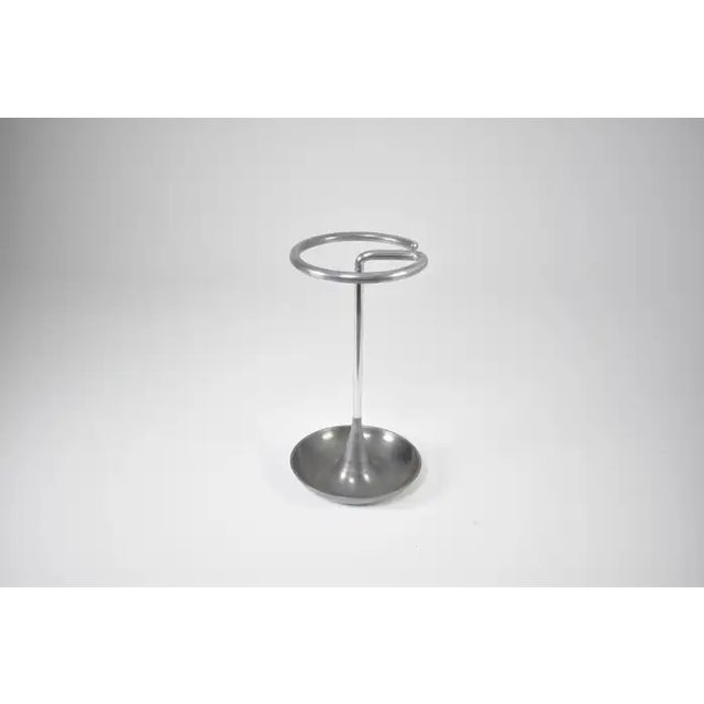 An American vintage umbrella stand from the 1960s in brushed aluminum, characterized by its circular upper ring, slender...