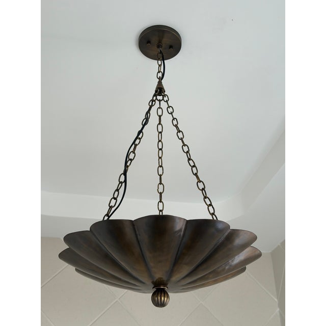 A handcrafted flower pendant light made from 100% solid brass. Its layered petal shade and antique brass finish make it a...