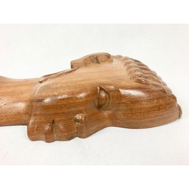 Dimensions given for a larger sculpture of a woman.