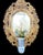 An incredible solid wood carved with gold gilt oval wall mirror. The mirror is very heavy with gorgeous gold leaf gilt and...