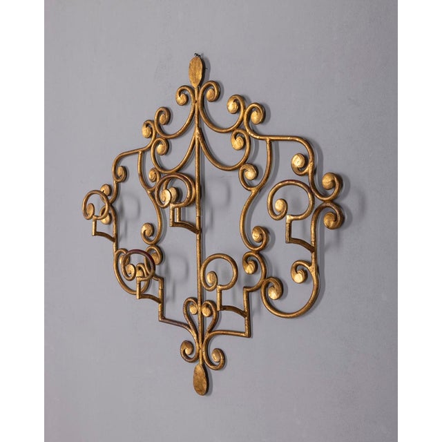Wall coat rack with floral motifs, in wrought iron and gold, Italian design, 1950s.