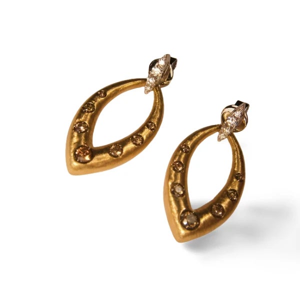 14K two-tone gold earrings featuring 14 champagne diamonds and 8 white diamonds, totaling 0.70 carats. Each earring...