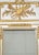 White painted wall mirror having carved flaming torch and quiver giltwood decoration, above the original bevelled mirror...