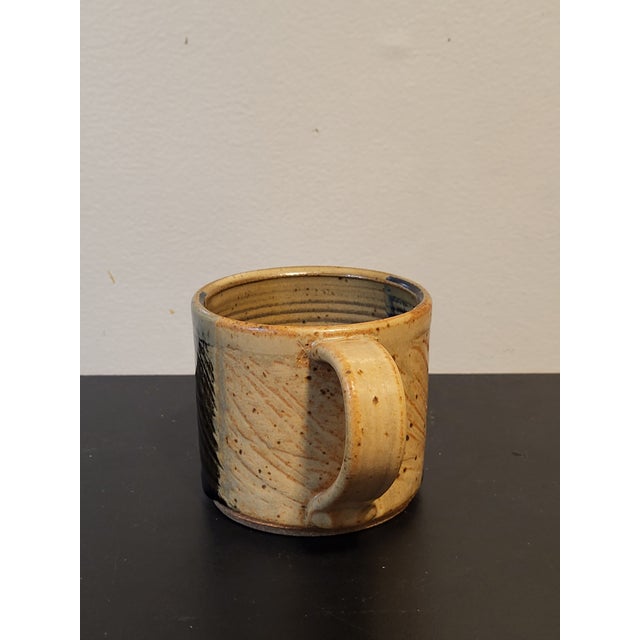 Textured and pottery glaze pattered stoneware mug signed by artist.