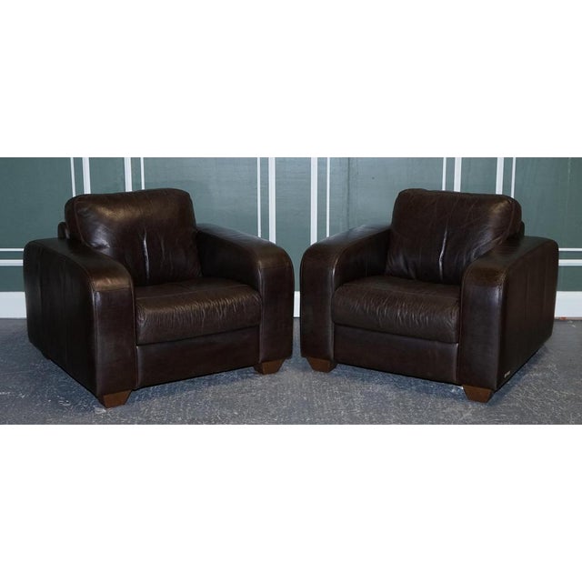 Stunning chocolate brown leather pair of armchairs. The armchairs are made by Sofitalia which is an established Italian...
