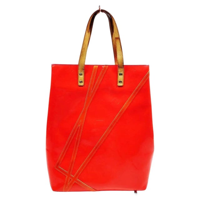 This exceptional and highly collectible piece of fashion history is a 2002/2003 limited edition Louis Vuitton Reade Tote...