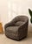 A bold vintage postmodern club chair with a rounded, enveloping silhouette and graphic black-and-tan upholstery. The...