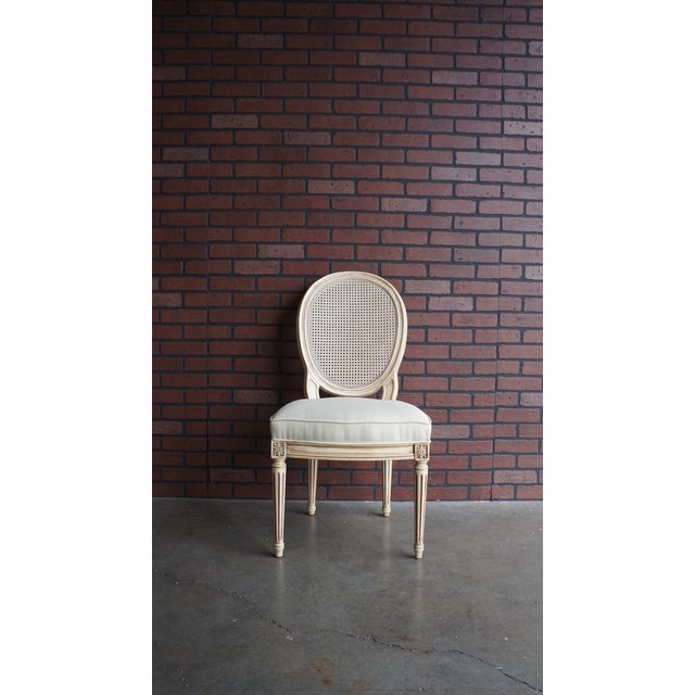 Henredon French Louis style cane back dining chairs. The upholstered box welted seat cushions is a neutral cream with soft...