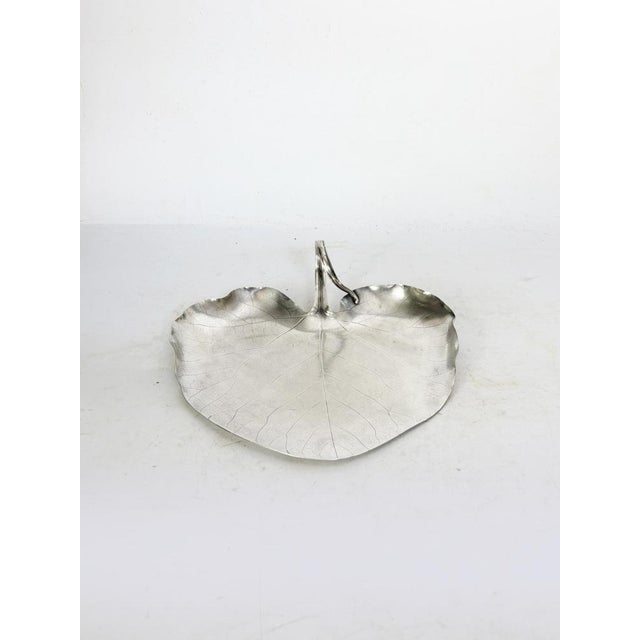 A silver-plated metal trinket tray produced by Christofle, France, in the 1970s, with a refined design inspired by nature....
