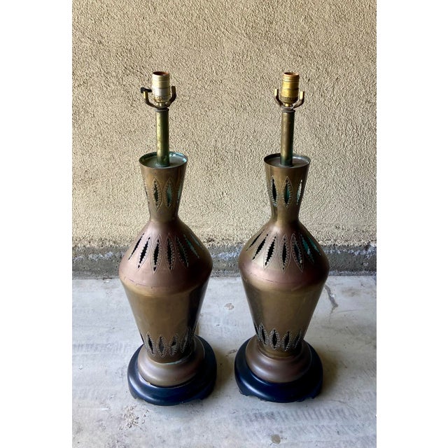 Set of two tall, vintage perforated metal Moroccan table lamps, in a copper/brass aged patina (metal type unknown), set on...