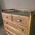 Cane and Bamboo Chest of drawers with detailing at the top the cupboard has 5 drawers with 2 bamboo handles on each...