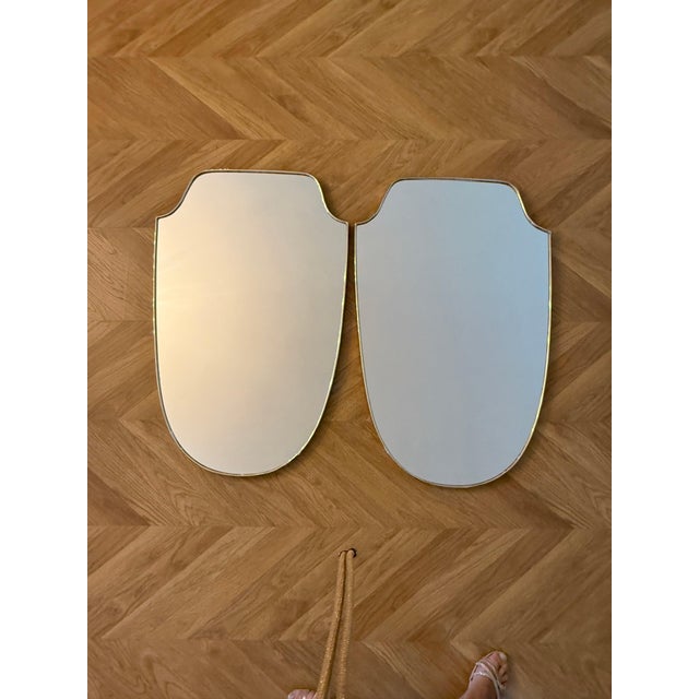 These modernist brass wall mirrors from the 1950s, in the style of Gio Ponti, are highly decorative pieces made in Italy...