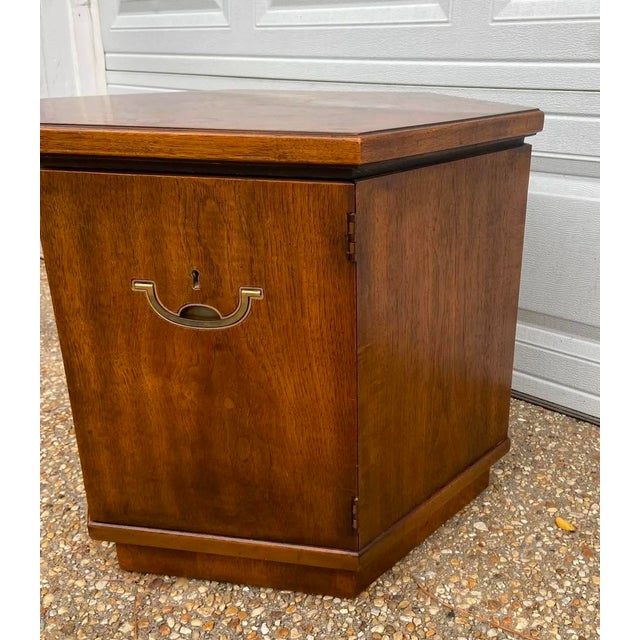 Classic mid century Drexel cabinet-style side table with brass campaign-style hardware. Solid wood construction which...