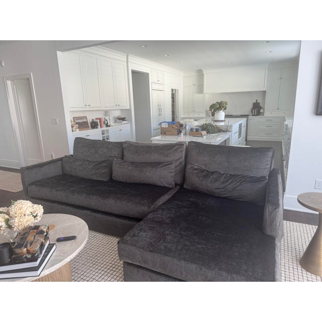 A substantial and beautifully tailored 105” Kipton Wide-Arm Sofa by Arhaus, upholstered in Banks Midnight — a rich, deep...